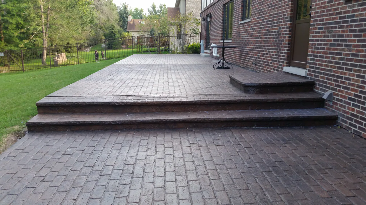 Brick-pattern stamped concrete patio with steps