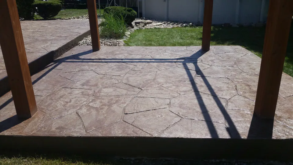 Stamped concrete patio with a pergola in the southwest Chicago suburbs